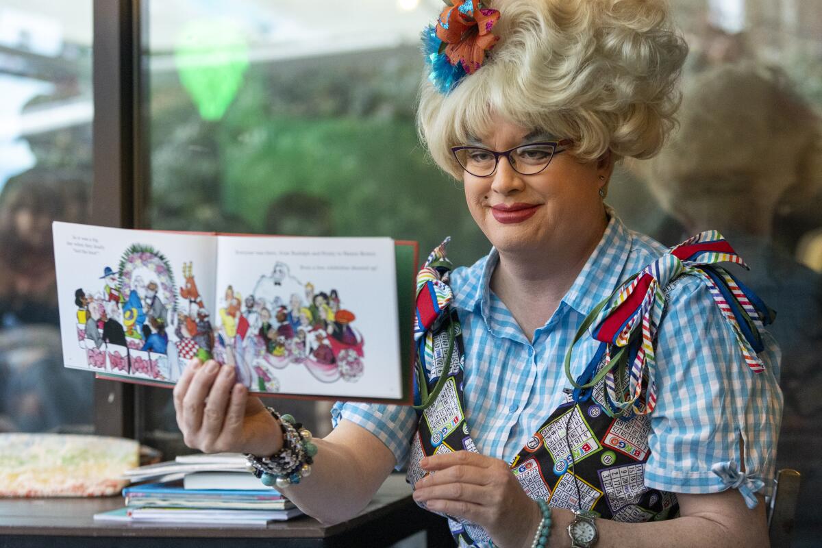 A drag queen reads to kids and parents.