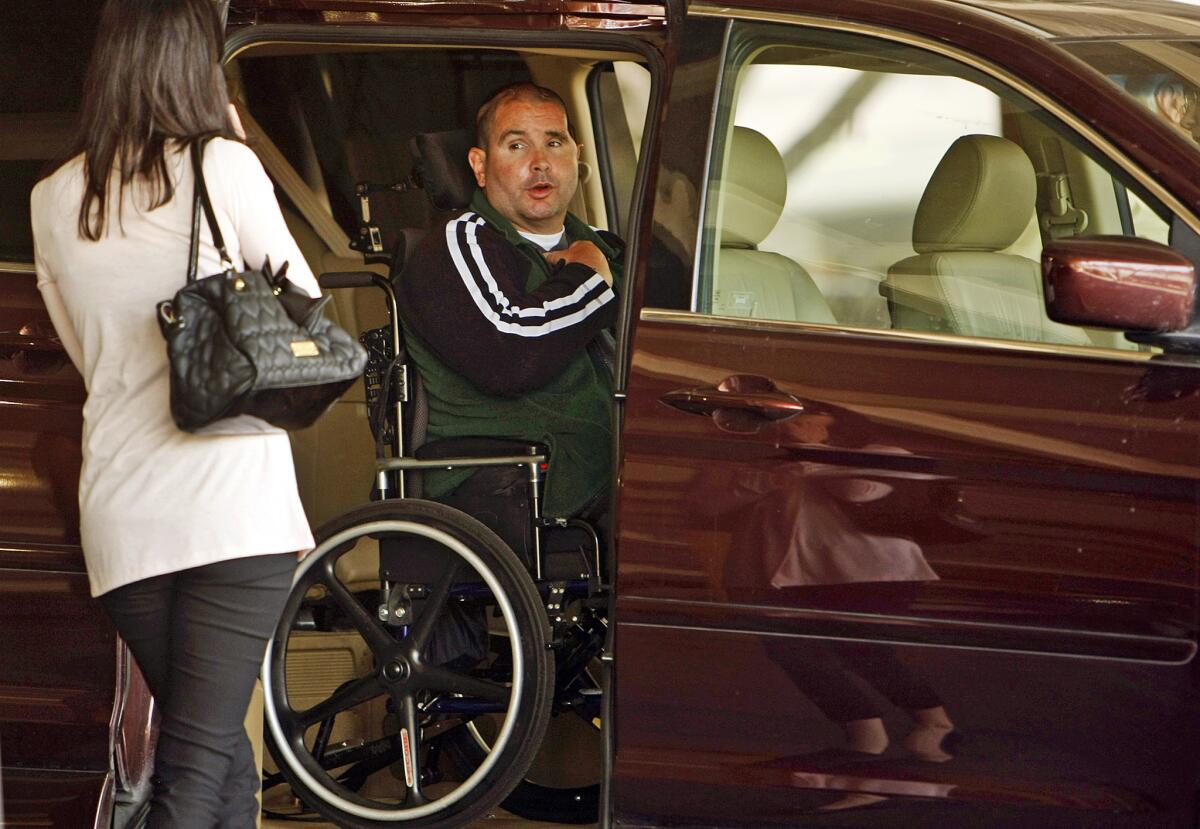 A wheelchair-bound Bryan Stow says goodbye to his sister Bonnie Stow after he is assisted by a caregiver into a special van as he departs the Los Angeles County Superior Courthouse in downtown L.A. on May 28.