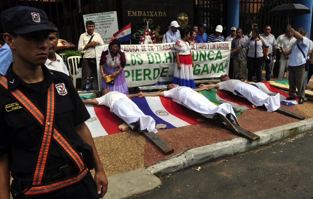 Protesters in Paraguay claim they are owed several thousand dollars for work many years ago on the Itaipu Dam, one of the world's biggest hydroelectric projects.