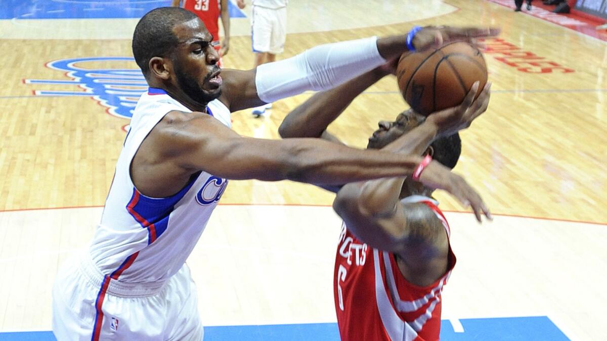 Clippers guard Chris Paul, left, defends against Houston Rockets power forward Terrence Jones during the Clippers' 119-107 loss in Game 6.