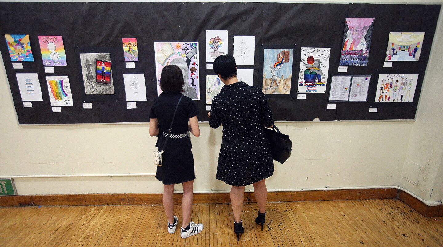 Angelina Robles, 14, and her mother Daniele Turiace, of Glendale, looked at each piece of artwork and have a conversation about what they are seeing at the opening night of the PRIDE art show at Crescenta Valley High School on Monday, May 13, 2019. There are 45 art submissions from throughout the Glendale Unified School District, including elementary, middle, and high school pieces. The best of which will be showcased in the city of Glendale's PRIDE 2019 art show at the Ace 121 Art Gallery.