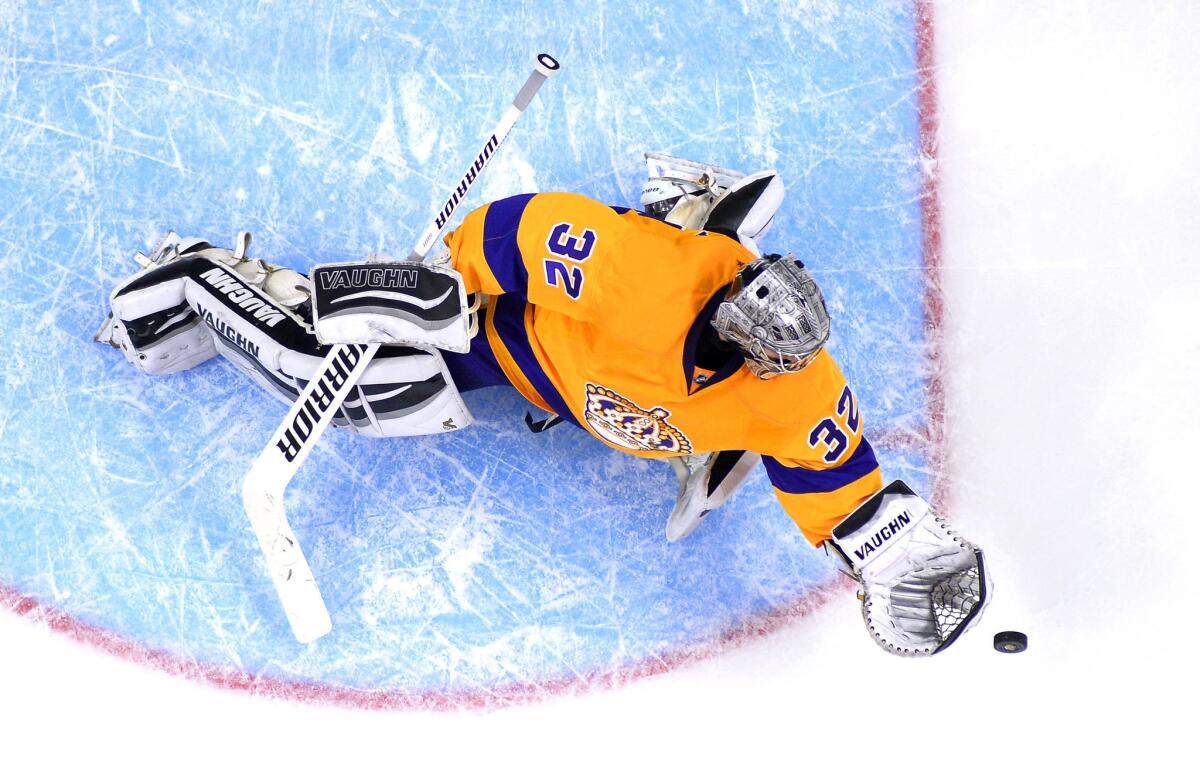 Kings goalie Jonathan Quick makes a glove save during the second period against the Coyotes.