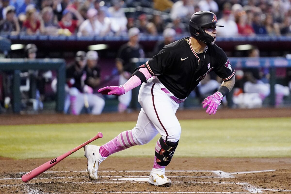 Arizona Diamondbacks' Jose Herrera watches the flight of his two-run double against the Colorado Rockies in the second inning of a baseball game Sunday, May 8, 2022, in Phoenix. (AP Photo/Ross D. Franklin)
