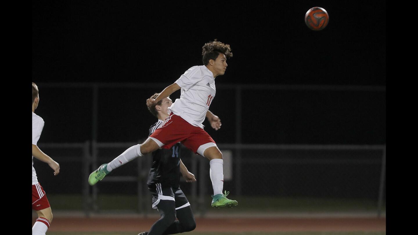 Estancia High’s Nico Ramirez heads the ball during the first half against Corona del Mar in a nonleague match on Friday.