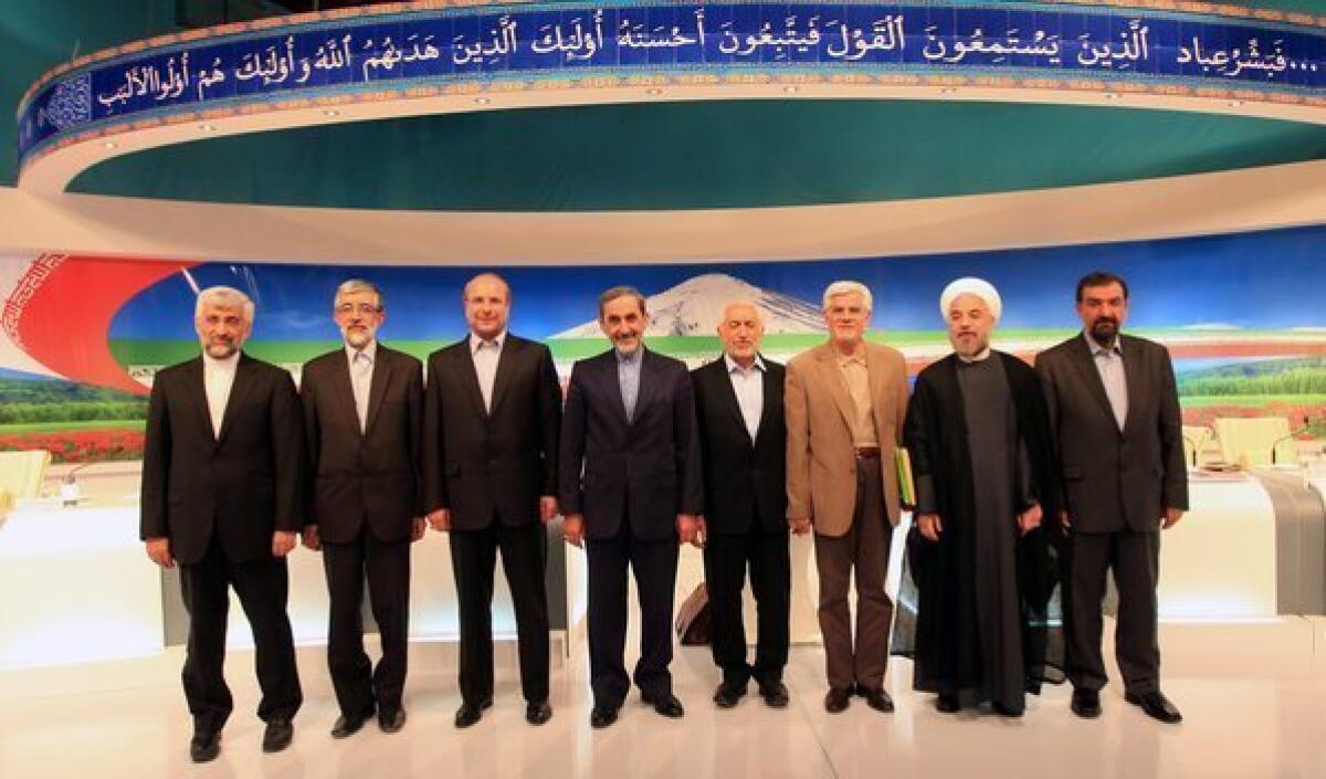 Eight Iranian presidential candidates, from left, Saeed Jalili, Gholam Ali Haddad Adel, Mohammad Bagher Qalibaf, Ali Akbar Velayati, Mohammad Gharazi, Mohammad Reza Aref, Hasan Rowhani and Mohsen Rezaei, pose for a group picture after their television debate in Tehran on Friday.