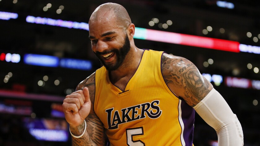 Lakers forward Carlos Boozer celebrates after drawing a foul while scoring during a win over the New York Knicks at Staples Center on March 12.