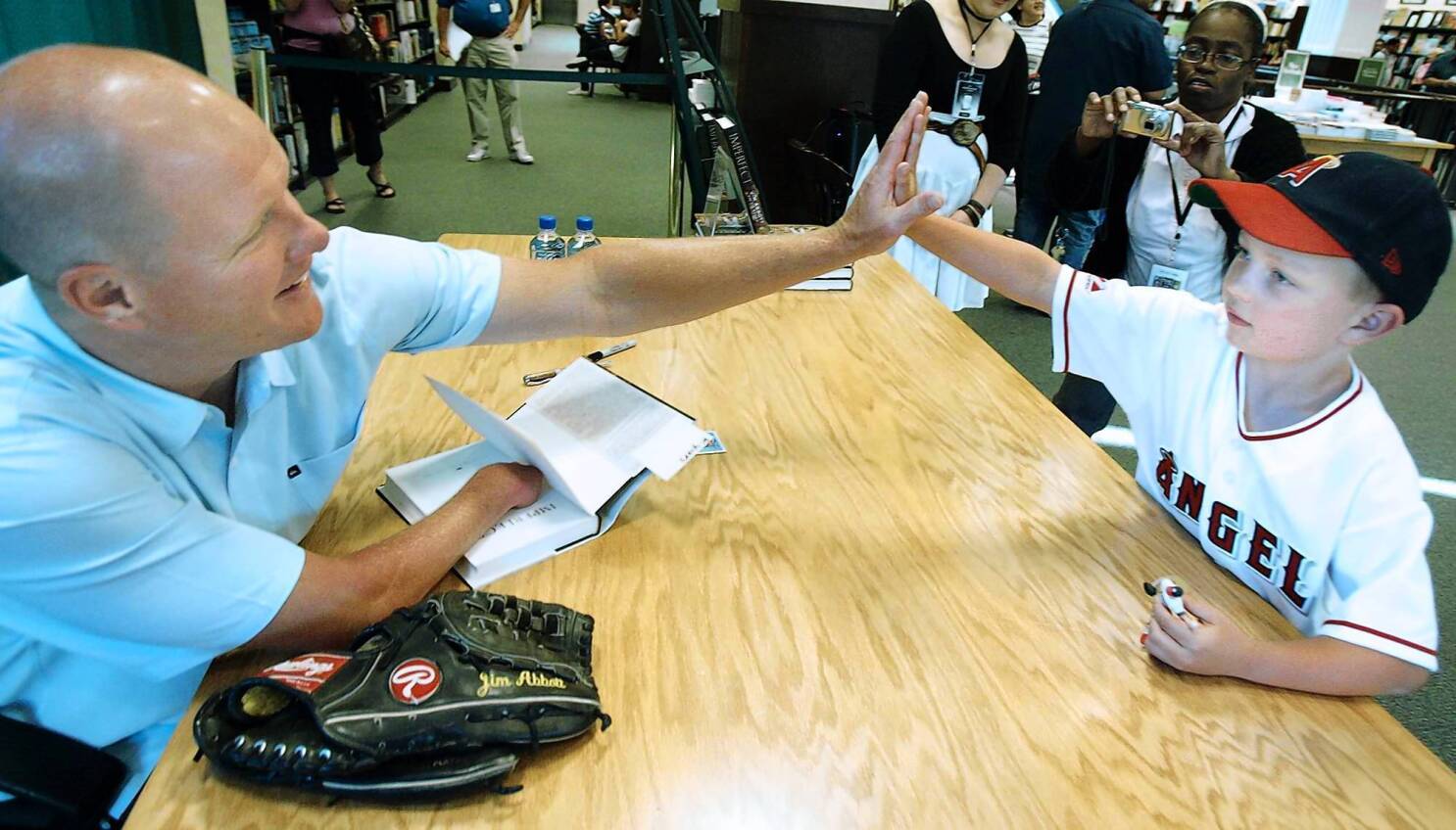 Jim Abbott of the California Angels meets on the mound with his