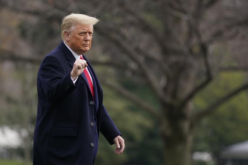 President Donald Trump gestures as he walks on the South Lawn of the White House in Washington, Saturday, Dec. 12, 2020, before boarding Marine One. Trump is en route to the Army-Navy Game at the U.S. Military Academy in West Point, N.Y. (AP Photo/Patrick Semansky)