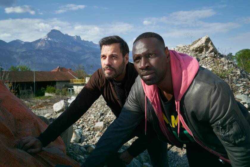 Two men against a mountainous backdrop in the movie "The Takedown."