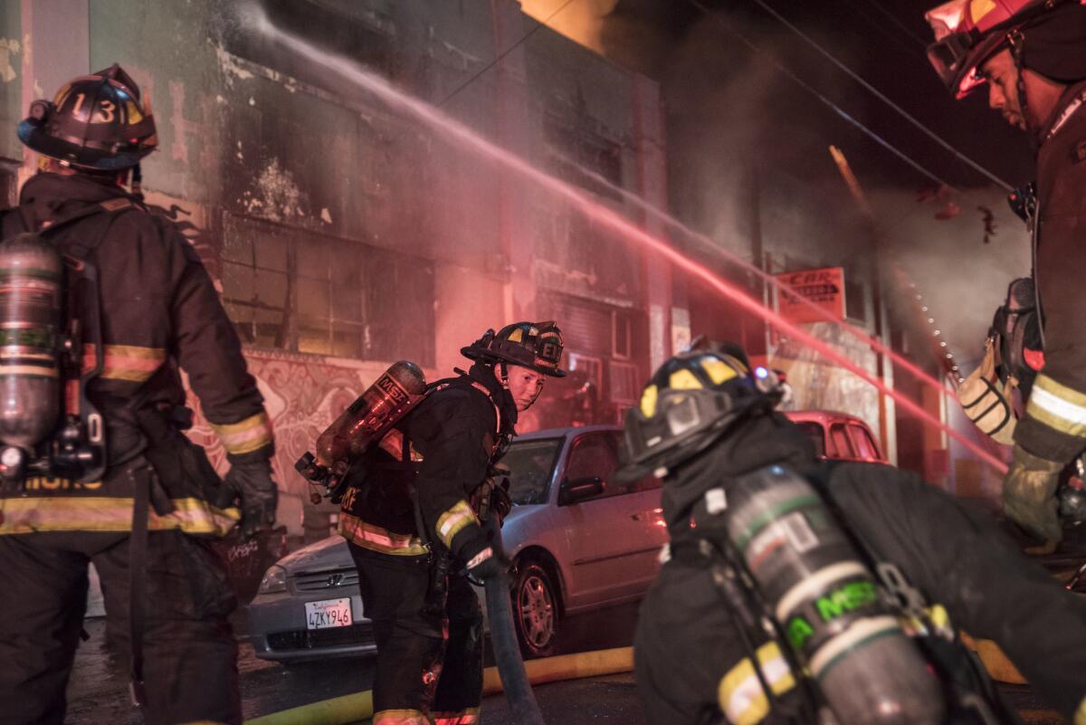 Firefighters battle a warehouse fire in Oakland that claimed the lives of 36 people during a concert. (David Butow / Redux)