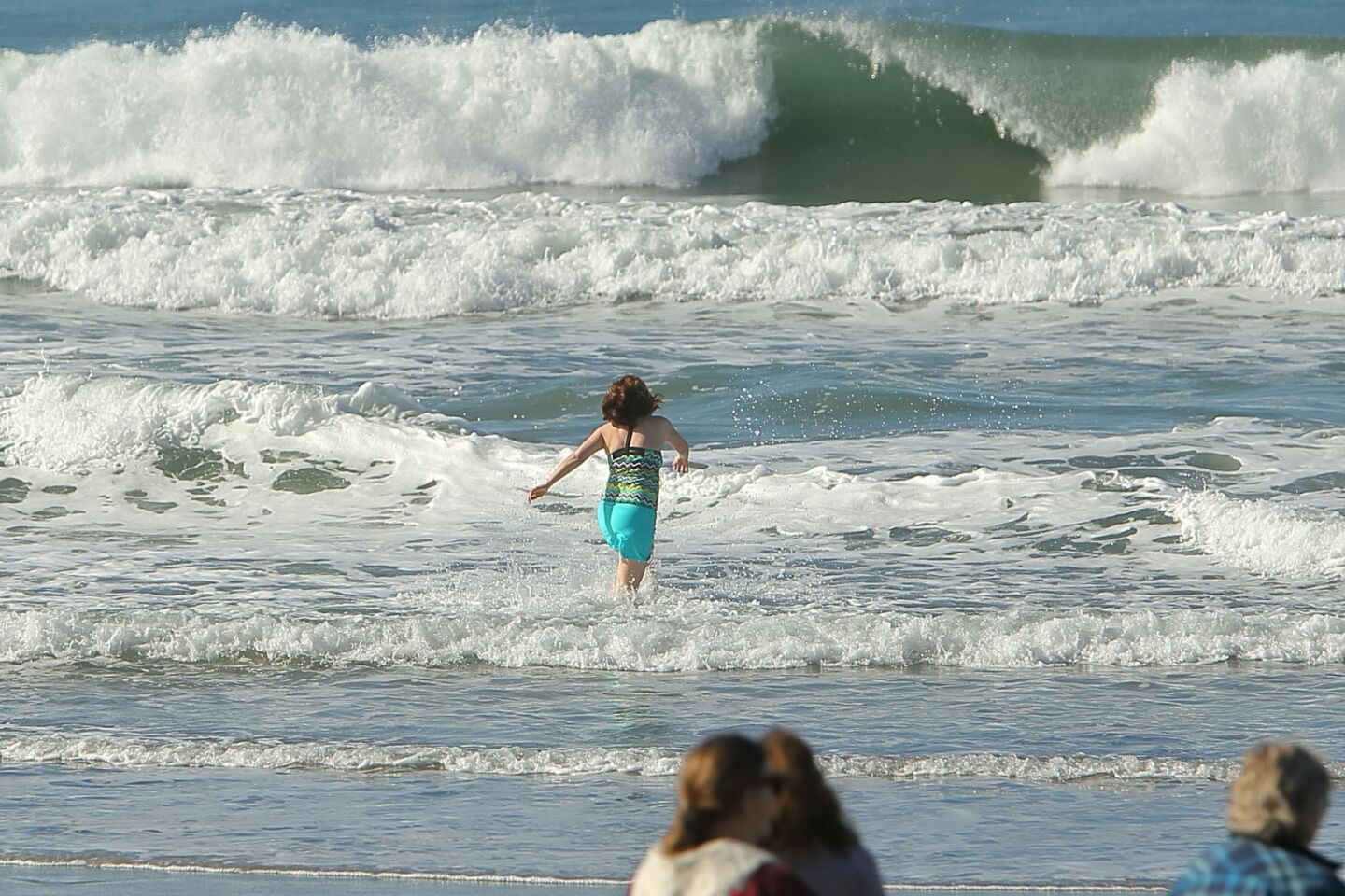 A member of the San Dieguito Boogie Babes plunged into the ocean on New Years Day 2022 at Fletcher Cove in Solana Beach