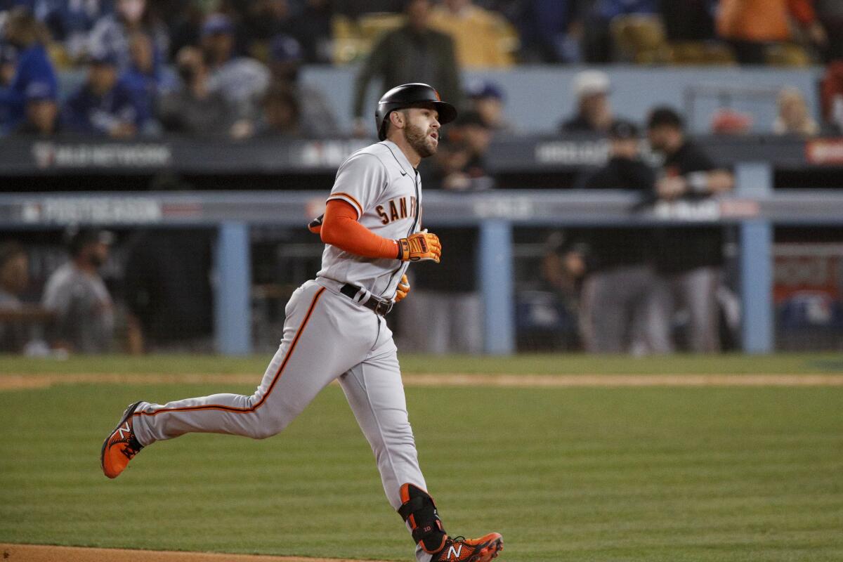San Francisco's Evan Longoria rounds the bases after hitting a solo home run in the fifth inning.
