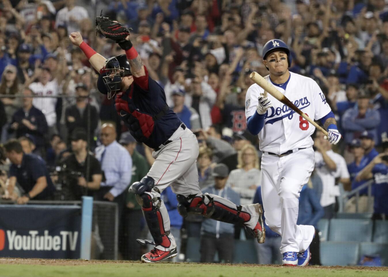 Dodgers' Manny Machado strikes out as Red Sox catcher Christian Vazquez charges to the mound to celebrate winning the 2018 Word Series.