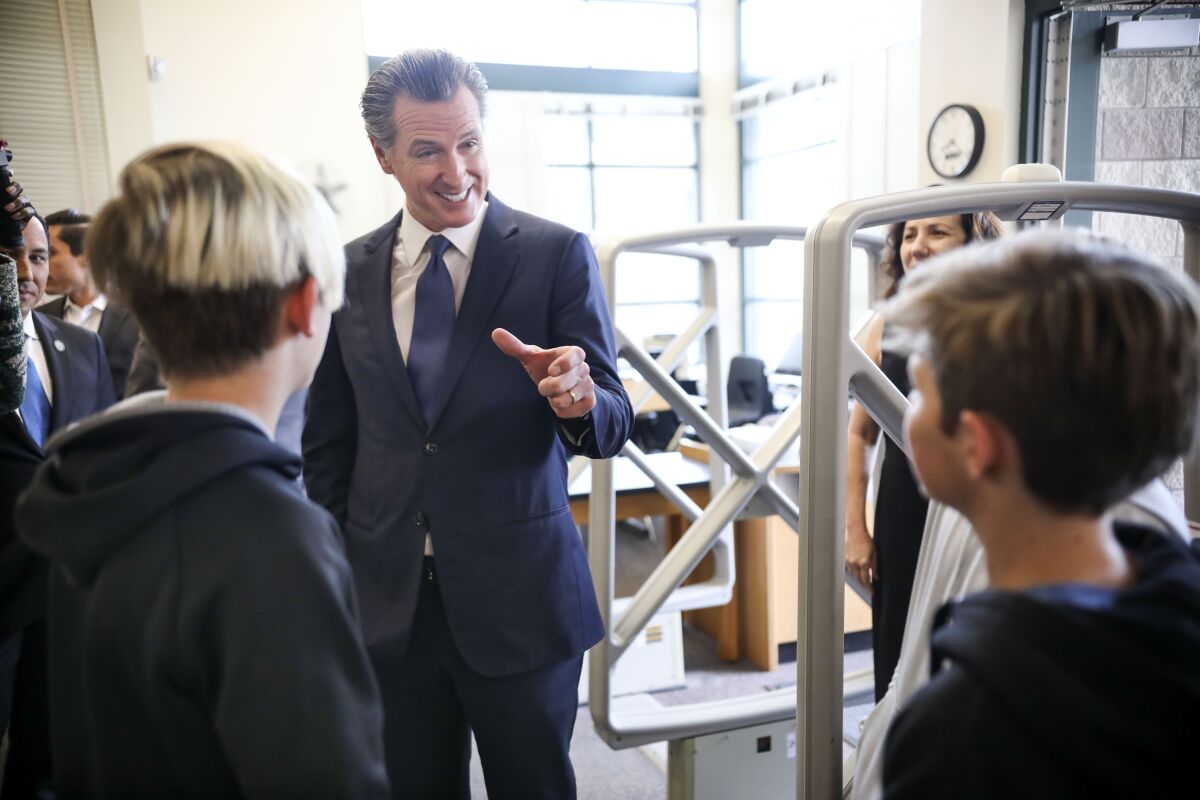 Gov. Gavin Newsom speaks with students while taking a tour of Dana Middle School in Point Loma on Feb. 28, 2020.