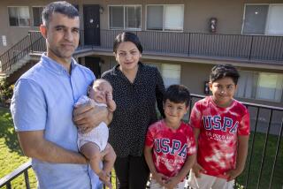 San Diego, CA - September 22: Hamid and Masooda Qazi, shown with their kids Dewa, 2 months old, Hasib, 6, and Habib, 10, at their San Diego apartment. Hamid and Masooda worked as attorneys in their native Afghanistan, with successful careers working for the Afghan and U.S. governments, before the fall of Kabul, when they were forced to flee with their two young sons for their safety. They have since immigrated to San Diego, had a baby girl, and are both looking to re-enter the legal field with some help from local attorneys and judges. Photo taken in San Diego Thursday, Sept. 22, 2022. (Allen J. Schaben / Los Angeles Times)