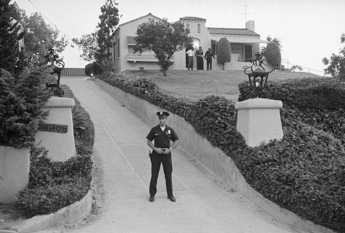 A police officer blocks the driveway in front of the house in Los Feliz in 1969.