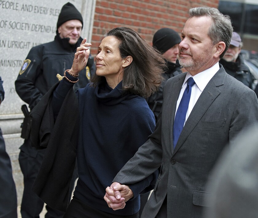 FILE - In this Friday, March 29, 2019, file photo, William McGlashan, right, of Mill Valley, Calif., arrives at the federal courthouse in Boston for a hearing in a nationwide college admissions bribery scandal. McGlashan, a former private equity executive who cofounded an investment fund with U2′s Bono was sentenced Wednesday, May 12, 2021, to three months in prison for his role in the college admissions bribery scheme. The former TPG Capital senior executive, admitted in February to paying $50,000 to have someone secretly correct his son's ACT answers. (Matt Stone/The Boston Herald via AP, File)