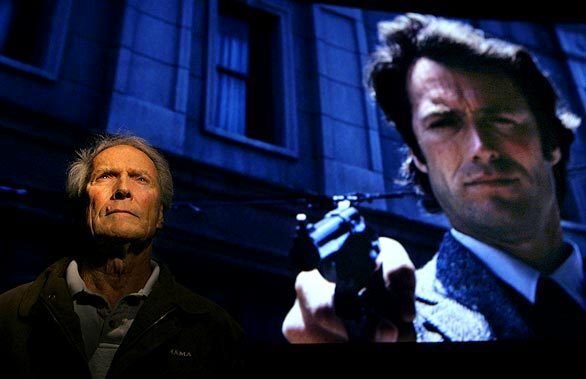 Clint Eastwood stands before a screen projecting a scene from his 1971 film "Dirty Harry" at the Steven J. Ross Theater on the Warner Bros. lot in Burbank. Warner Bros. is releasing a boxed set of the Dirty Harry films, in which Eastwood portrayed San Francisco police Inspector Harry Callahan. "Who's that young fella?" cracked Eastwood, gazing up at the screen.