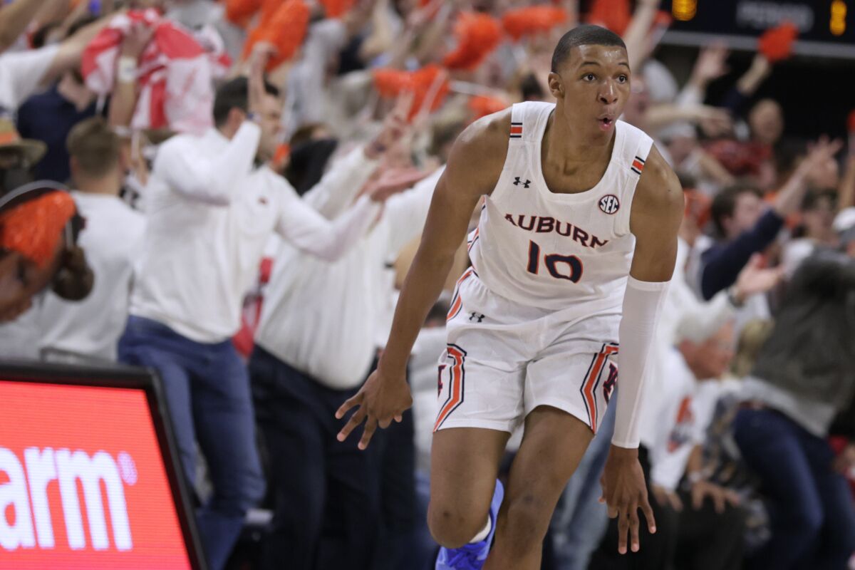 Auburn forward Jabari Smith reacts after making a three-pointer against Alabama.