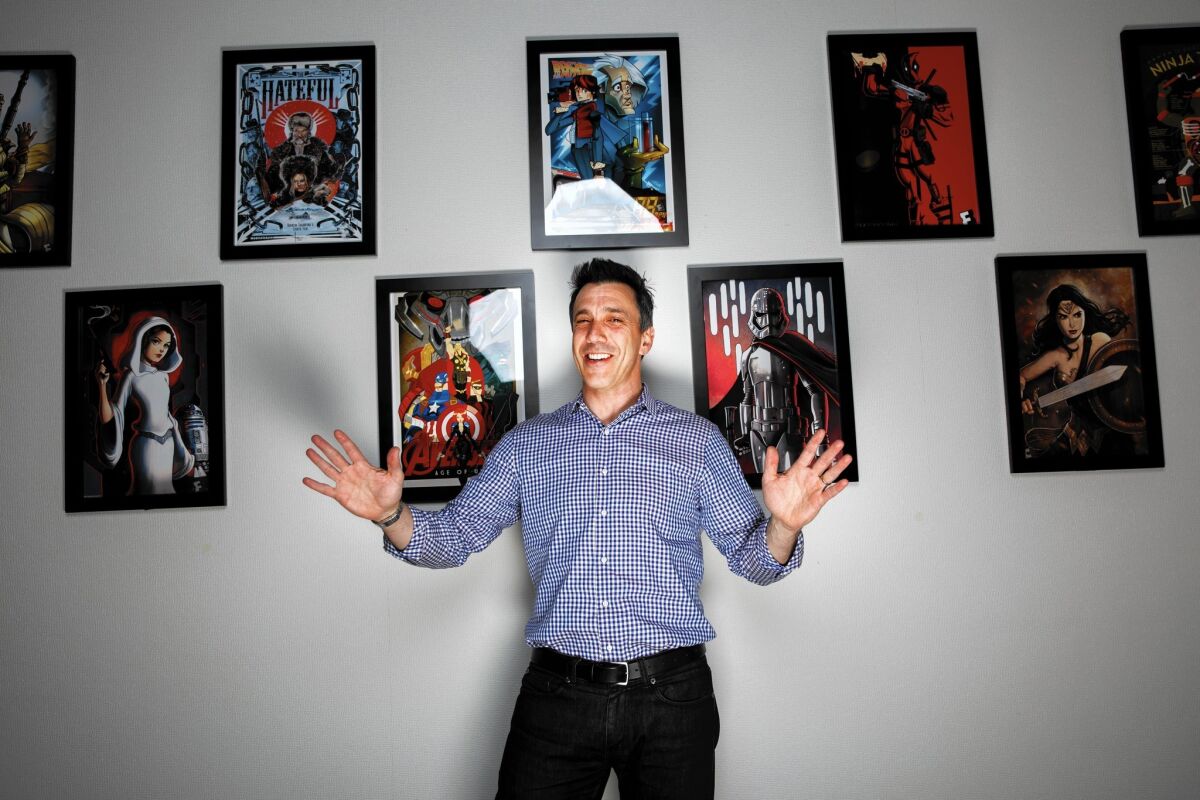 Fandango President Paul Yanover in front of fan art curated by the Los Angeles company to create moviegoing buzz.