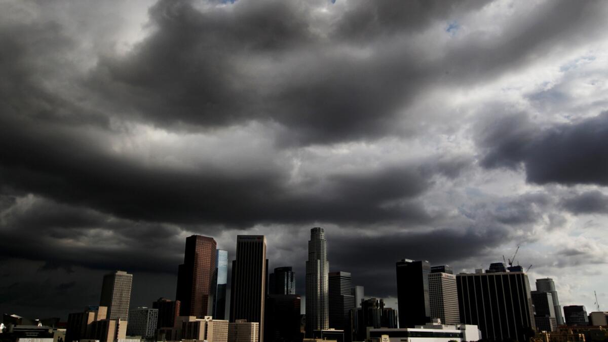 Storm clouds drift over downtown Los Angeles on Monday afternoon.