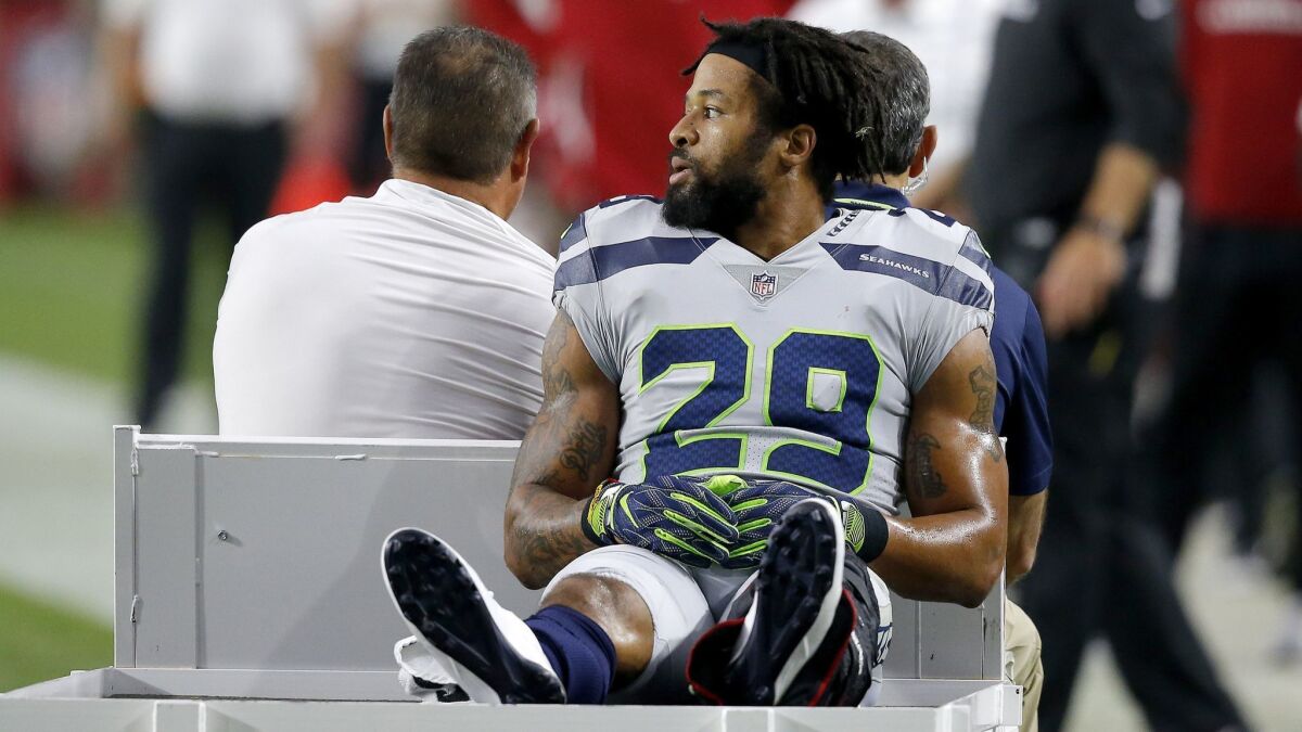 Seattle Seahawks defensive back Earl Thomas leaves the field after breaking his leg against the Arizona Cardinals.