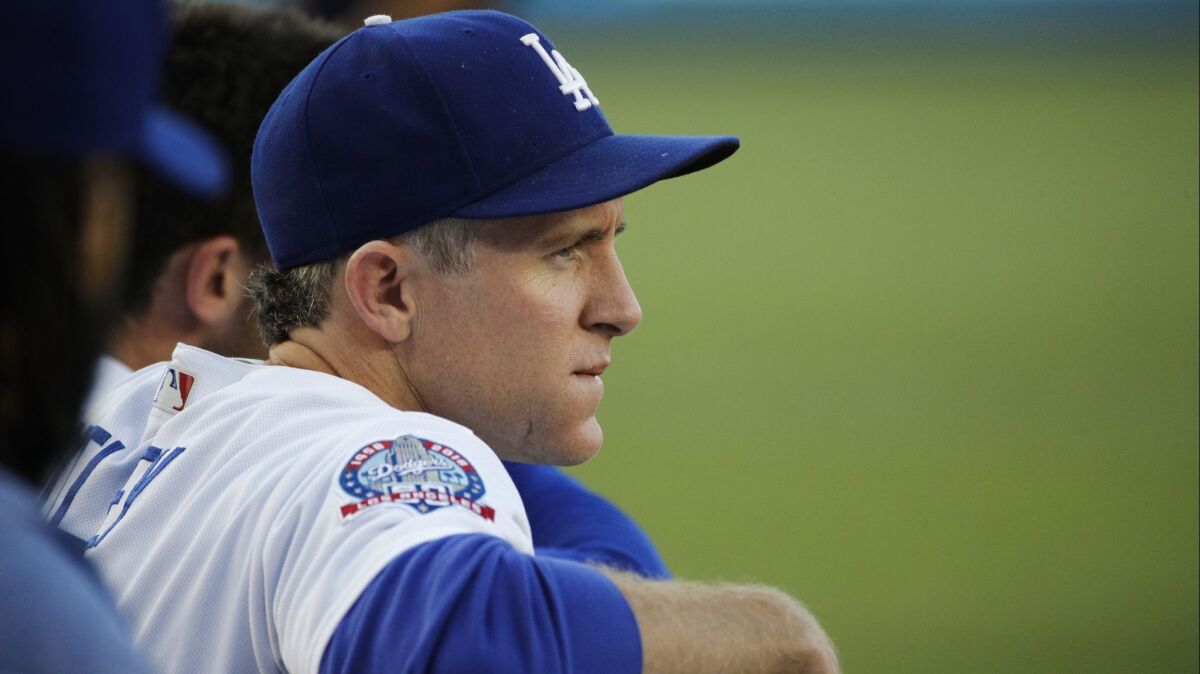 Dodgers' Chase Utley watches from the dugout during the first inning against the Angels on Friday at Dodger Stadium.