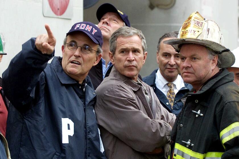 From left, New York City Mayor Rudolph Giuliani, New York Gov. George Pataki, President Bush, Sen. Charles E. Schumer and Fire Commissioner Thomas Van Essen inspect the damage three days after the attack.