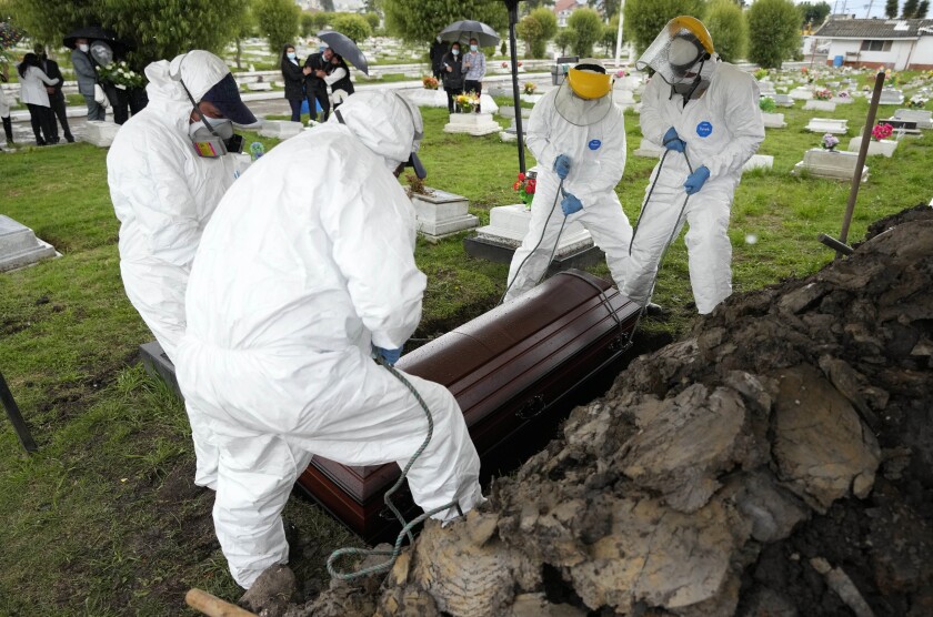 Cemetery workers lifting a coffin