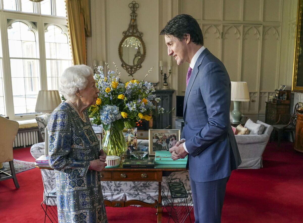 Britain's Queen Elizabeth II receives Canada's Prime Minister Justin Trudeau during an audience at Windsor Castle, Windsor, England, Monday March 7, 2022. (Steve Parsons/Pool via AP)