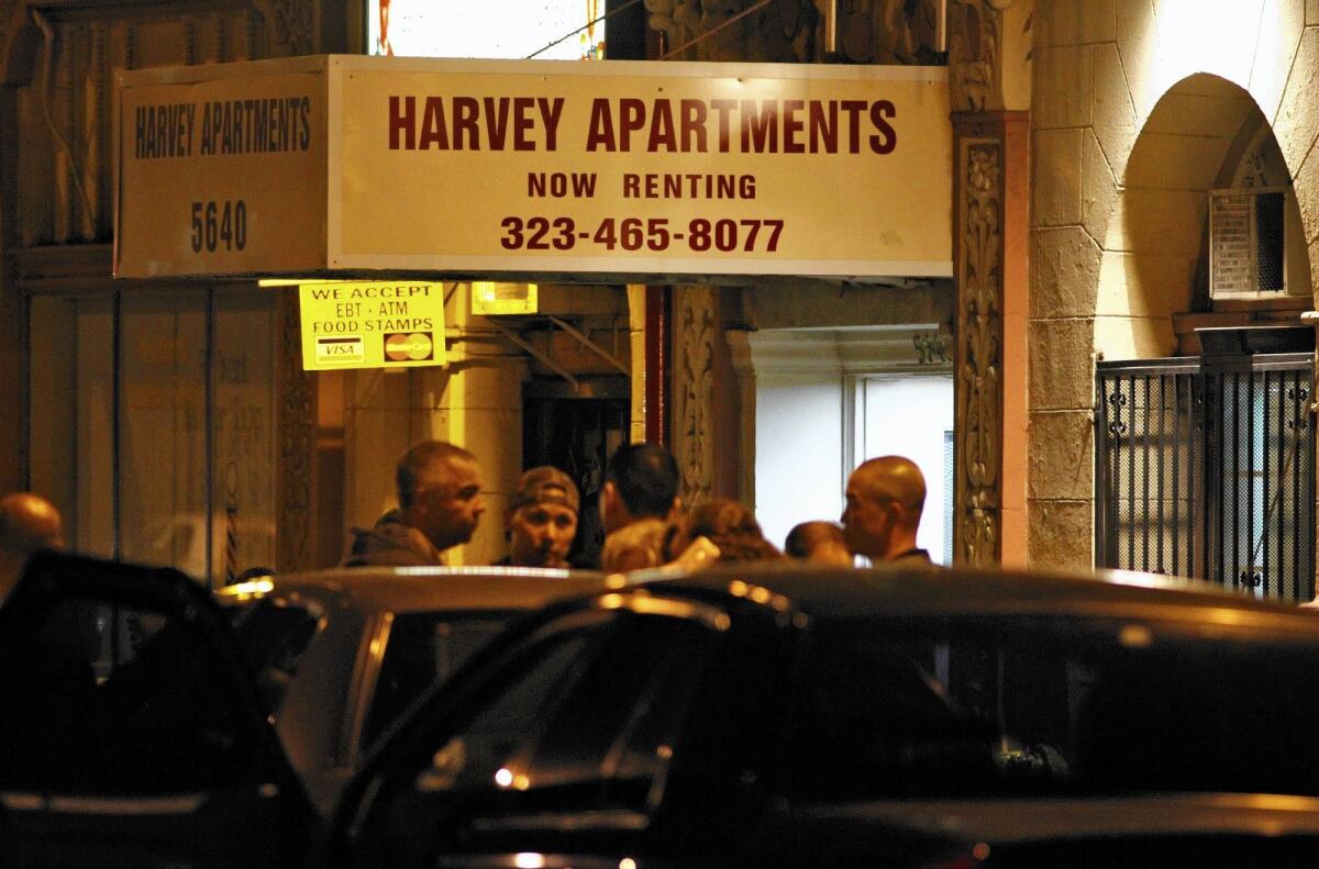 Investigators gather outside the Harvey Apartments on Santa Monica Boulevard on Dec. 1, 2010, shortly after Harold Martin Smith, later determined to be the man who killed Hollywood publicist Ronni Chasen, shot himself as police were preparing to question him.