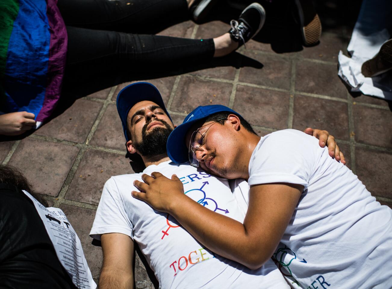 Noah Reich, left, and Dave Maldonado take part in a "die-in" at Los Angeles City Hall to protest gun violence in America.