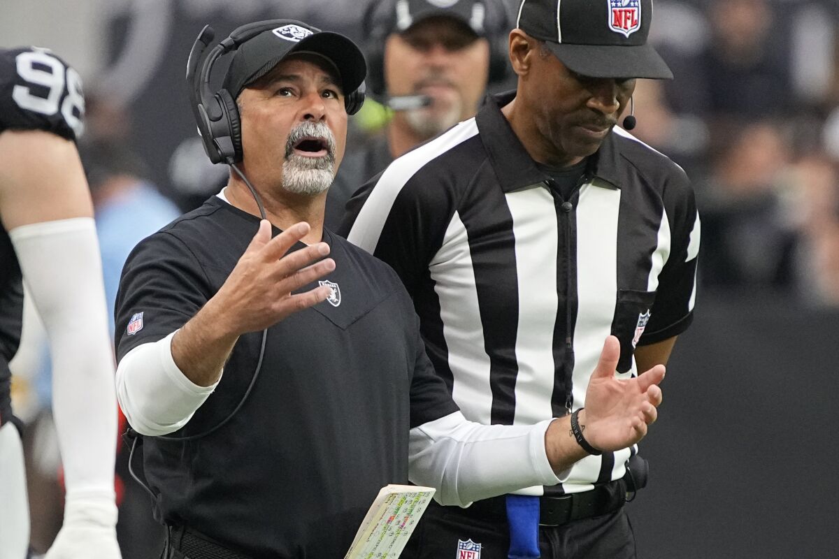Las Vegas Raiders interim head coach Rich Bisaccia motions towards the field during the first half of an NFL football game against the Philadelphia Eagles, Sunday, Oct. 24, 2021, in Las Vegas. (AP Photo/Rick Scuteri)