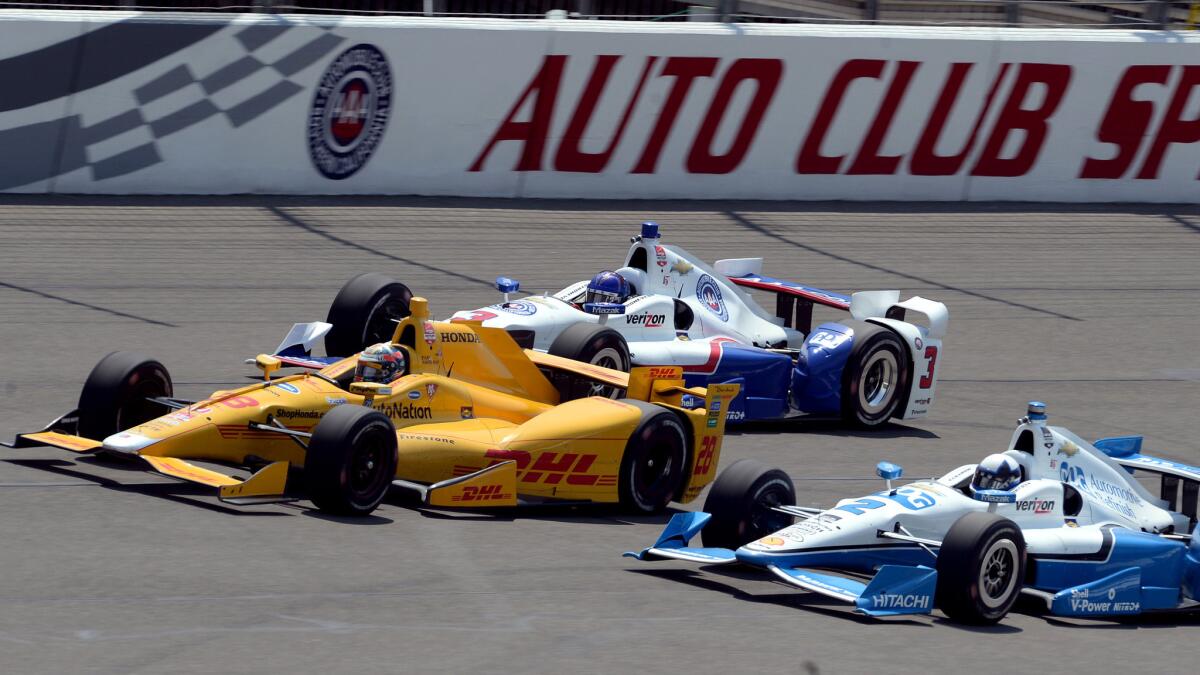 Ryan Hunter-Reay (28) leads Helio Castroneves (3) and Juan Pablo Montoya (2) in the front straightaway during a practice session at Auto Club Speedway on June 26, 2015.