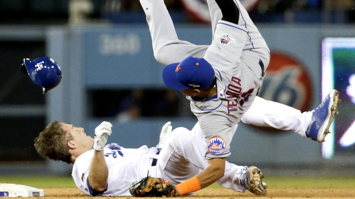 Mets shortstop Ruben Tejada, who sustained a broken leg on the play, is sent tumbling by the slide of Dodgers second baseman Chase Utley during a playoff game last fall.