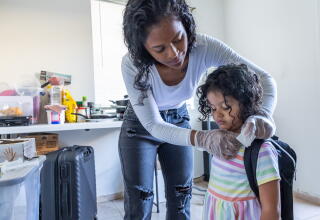 a woman runs a saline solution through her daughter's intravenous line