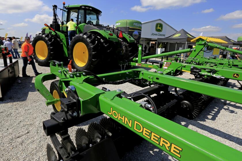 FILE - In this Sept. 10, 2019, file photo a John Deere tractor is on display at the Husker Harvest Days farm show in Grand Island, Neb. Deere & Co. reports earns on Thursday, Feb. 20, 2020. (AP Photo/Nati Harnik, File)