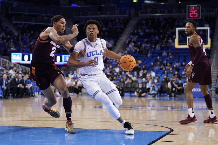 UCLA guard Jaylen Clark (0) is guarded by Arizona State forward Jalen Graham (2) during the first half of an NCAA college basketball game Monday, Feb. 21, 2022, in Los Angeles. (AP Photo/Marcio Jose Sanchez)