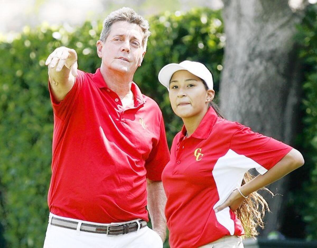ARCHIVE PHOTO: Coach Greg Osbourne and Jasmine Daniel, of Glendale Community College women's golf, spot a ball that was just driven off the first tee by a teammate during practice at Oakmont Country Club in Glendale on August 21, 2012. Osbourne will resign his position of both men and women's golf at GCC for a new post as director of golf at Cal State Bakersfield.