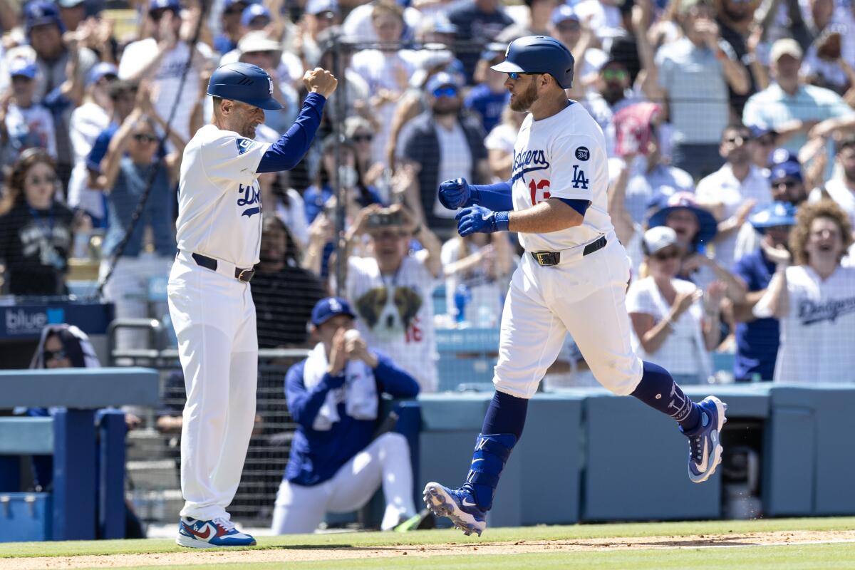 Max Muncy rounds third after hitting a grand slam Sunday.
