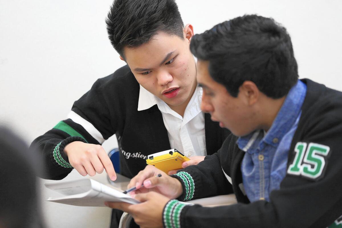Tanthai Pongstien, 17, left, and Fernando Sanchez, 18, practice math problems on April 14 as they prepare for the national round of the Academic Decathlon.