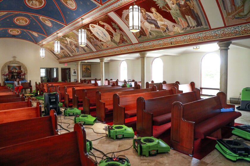 Fans were placed around St. Anthony's Antiochian Orthodox Church on Friday in an attempt to dry the floors after a flood caused by a vandal.
