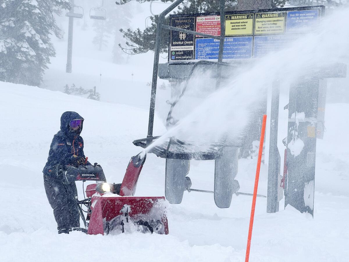 A ski resort employee clearing snow