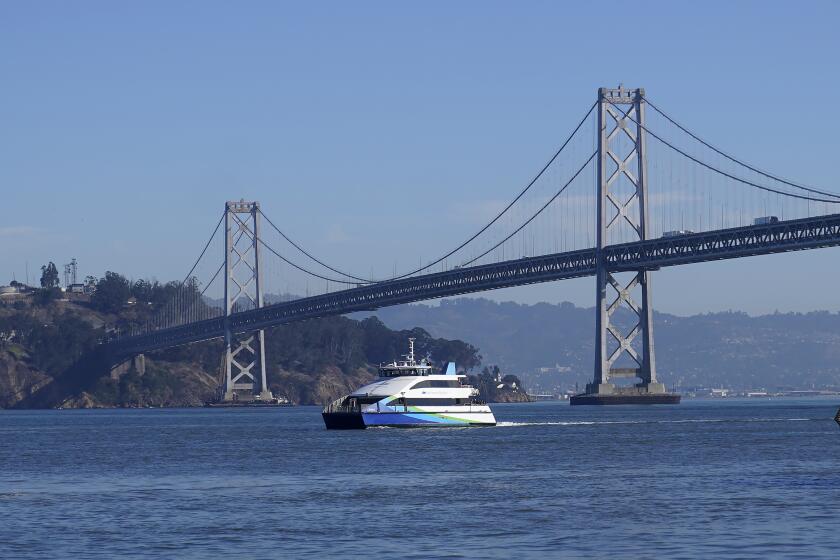 A San Francisco Bay Ferry is shown in front of the San Francisco-Oakland Bay Bridge in San Francisco, Thursday, Nov. 30, 2023.