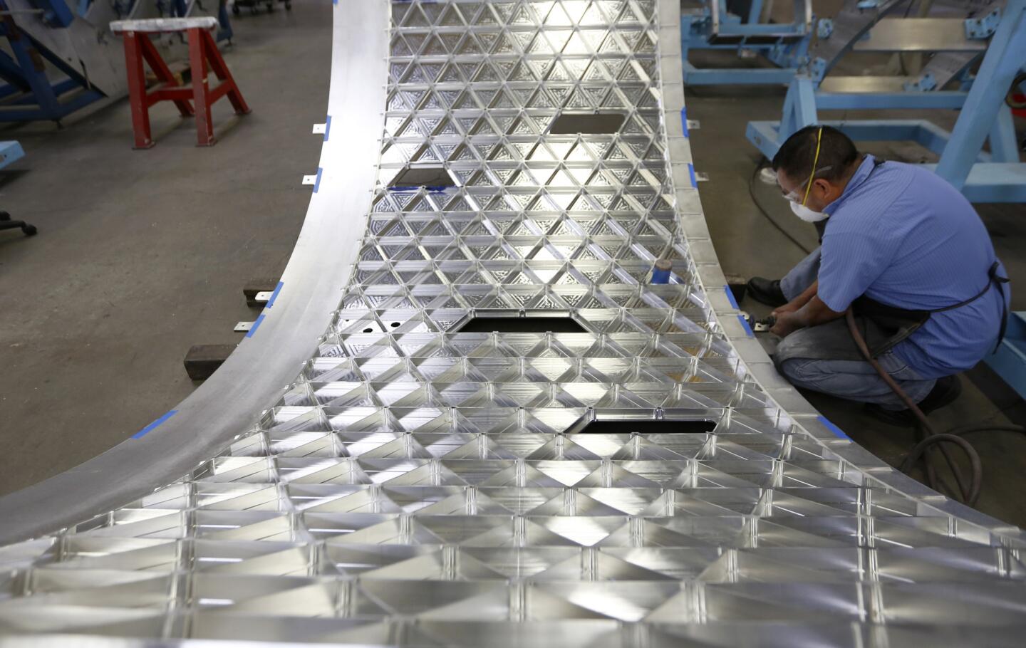 Technician Thomas Lopez works on a rocket panel at AMRO Fabricating Corp. in South El Monte. AMRO is responsible for the rockets that will send NASA's next manned mission to Mars.