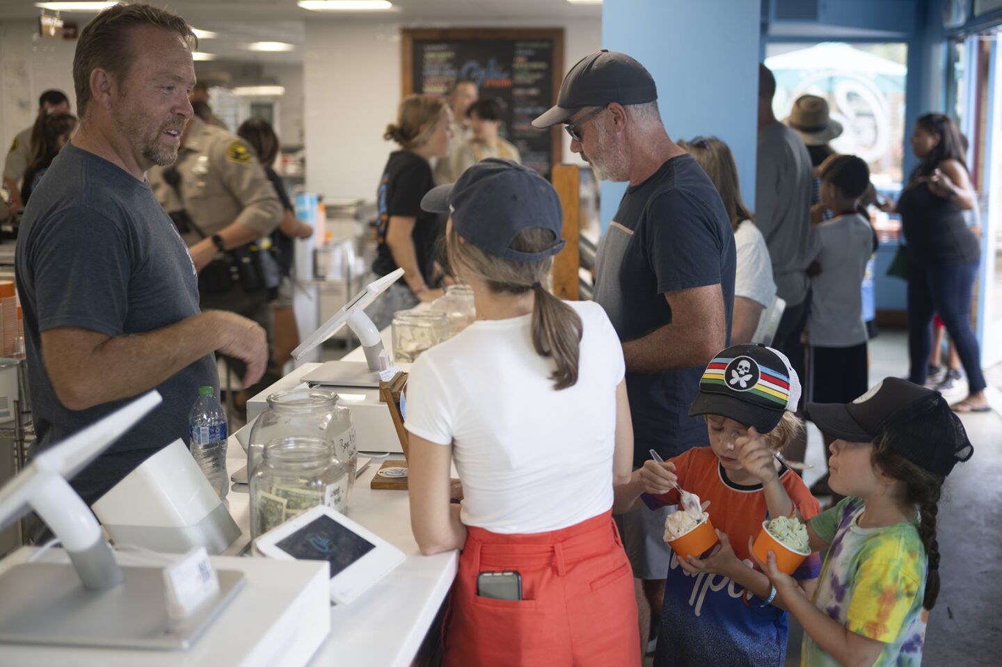 Cali Ice Cream owner Ken Schulenburg talks with the Young family