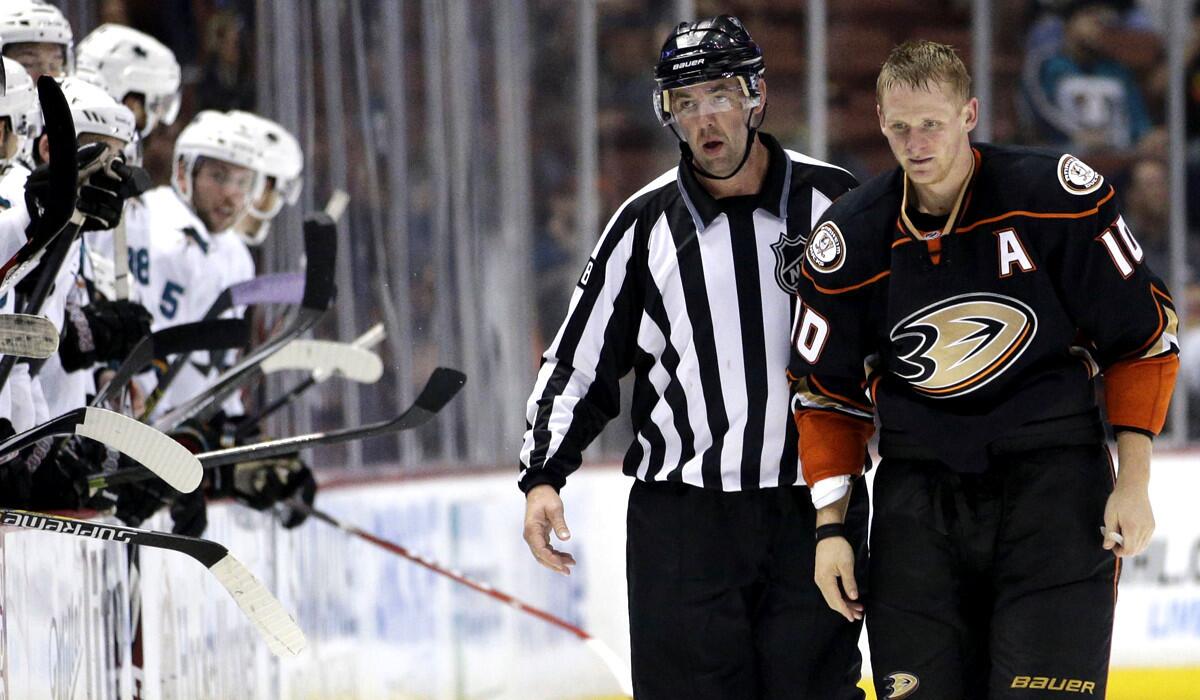 Ducks right wing Corey Perry (10) is escorted off the ice after drawing a misconduct penalty during the game against the Sharks on Sunday night in Anaheim.