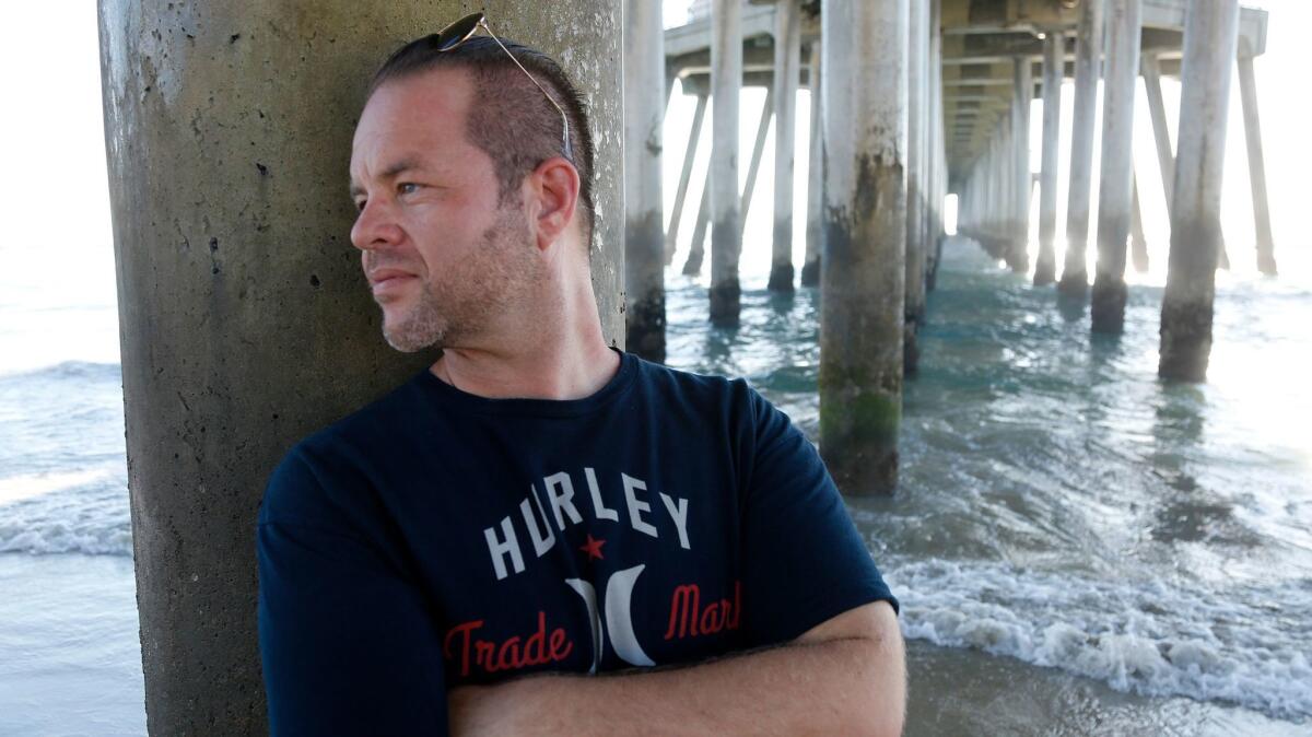 Anthony Miskulin, relaxing under the Huntington Beach Pier, discusses his reasons for voting Trump.