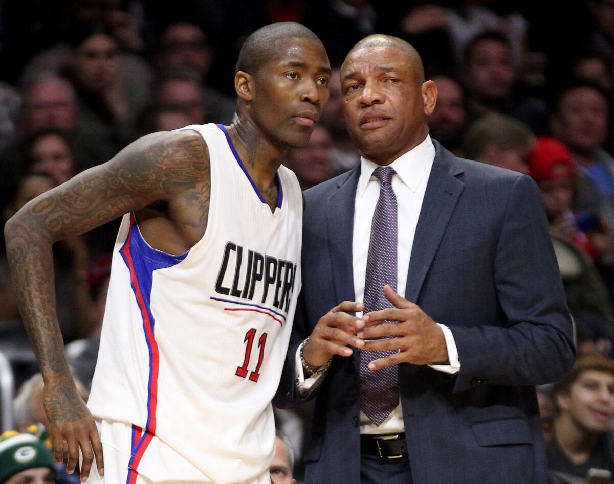 Clippers Coach Doc Rivers, right, talks to guard Jamal Crawford during the first half of a game against the Warriors on December 15.