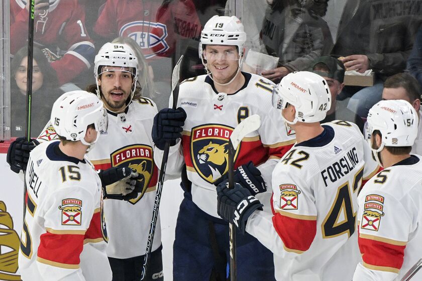 Florida Panthers' Matthew Tkachuk (19) celebrates with teammates after scoring against the Montreal Canadiens during the second period of an NHL hockey game Thursday, March 30, 2023, in Montreal. (Graham Hughes/The Canadian Press via AP)